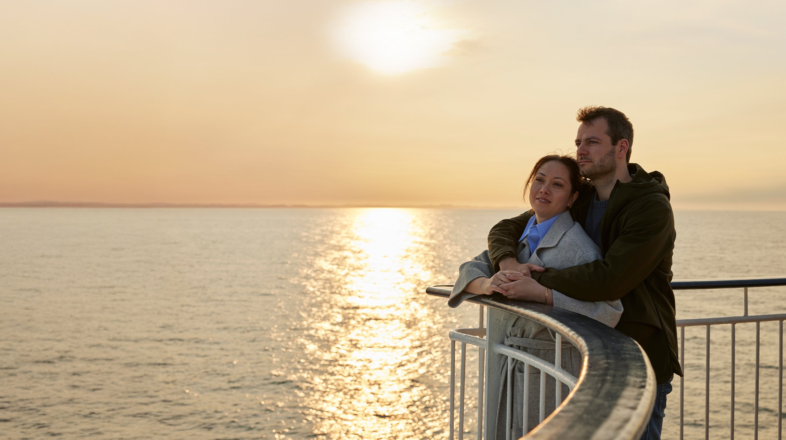 A couple in the sunset on the deck